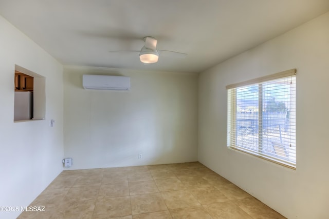 spare room with light tile patterned floors, an AC wall unit, and ceiling fan