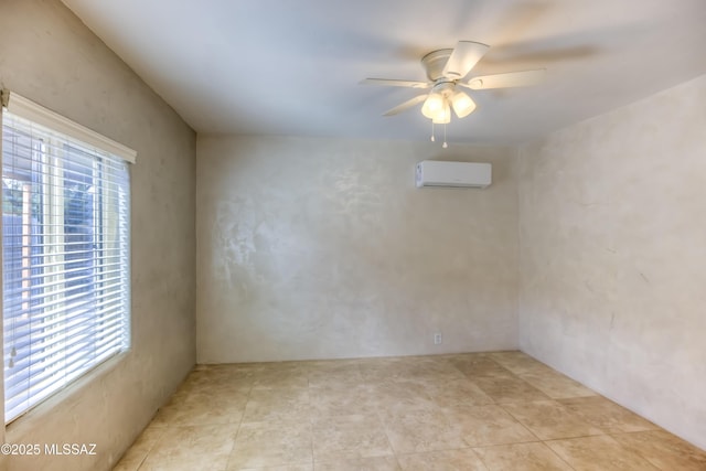 empty room featuring light tile patterned floors, an AC wall unit, ceiling fan, and a healthy amount of sunlight