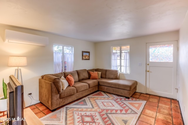 living room with a wealth of natural light, light tile patterned floors, and a wall mounted AC