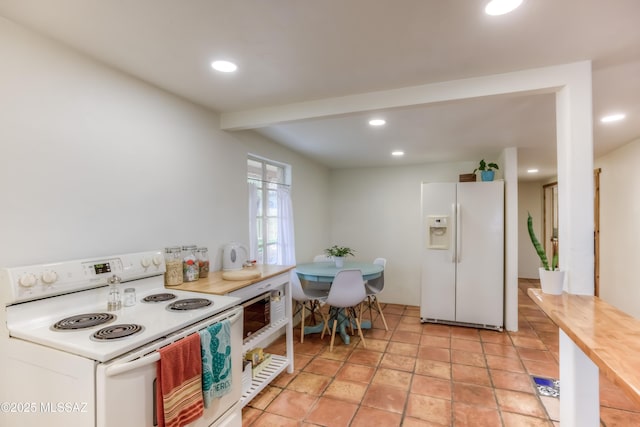 kitchen featuring recessed lighting, white appliances, and light countertops