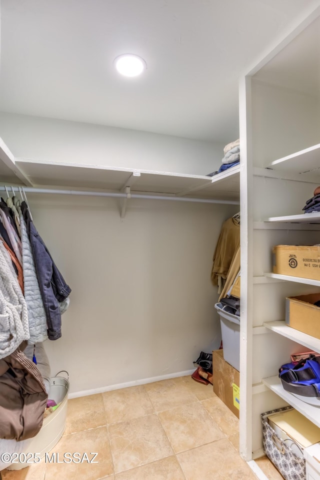 spacious closet featuring tile patterned flooring