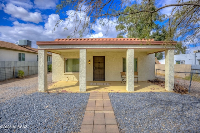 back of property featuring a patio area, fence, central AC, and stucco siding