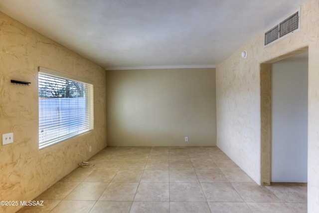 unfurnished room featuring light tile patterned flooring and visible vents