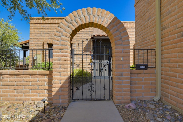 doorway to property with a gate and fence