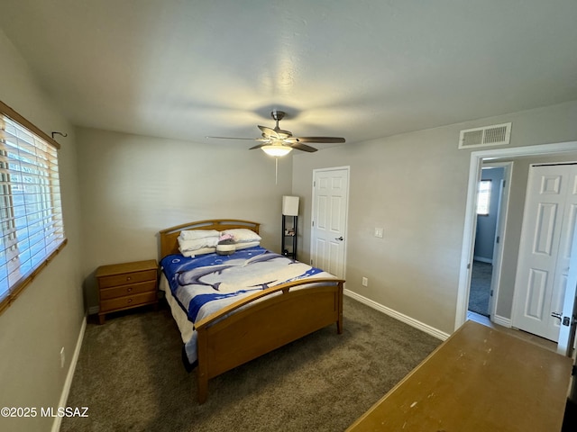 carpeted bedroom featuring visible vents, baseboards, and a ceiling fan