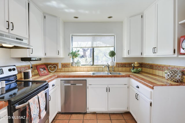 kitchen with light tile patterned flooring, a sink, white cabinetry, under cabinet range hood, and stainless steel appliances