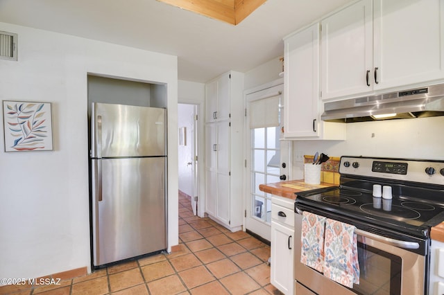 kitchen featuring white cabinets, under cabinet range hood, light tile patterned floors, and stainless steel appliances
