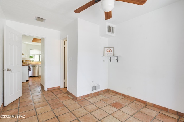 empty room featuring baseboards, ceiling fan, and visible vents