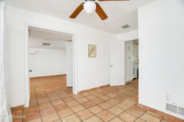 spare room with light tile patterned floors, baseboards, visible vents, and a ceiling fan