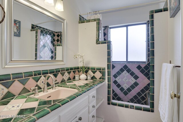 bathroom featuring tasteful backsplash and vanity