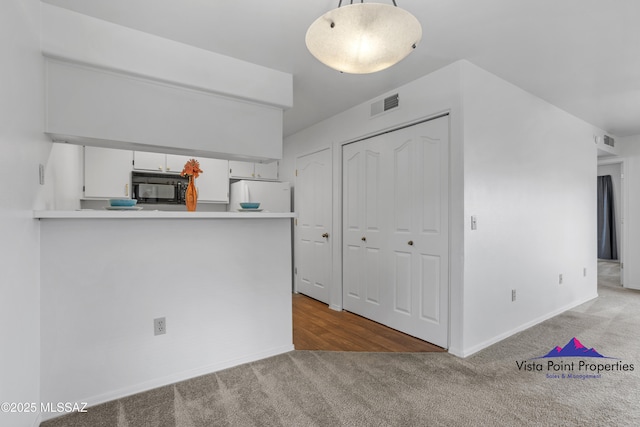 interior space with carpet flooring and visible vents