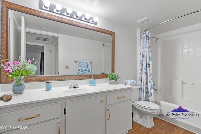 full bathroom with vanity, wood finished floors, visible vents, toilet, and shower / tub combo with curtain