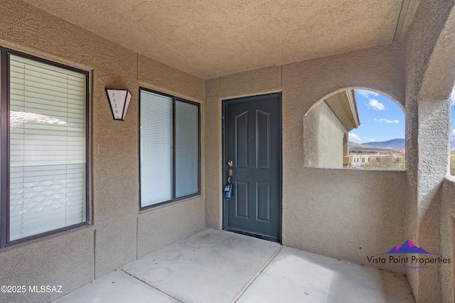 entrance to property featuring stucco siding