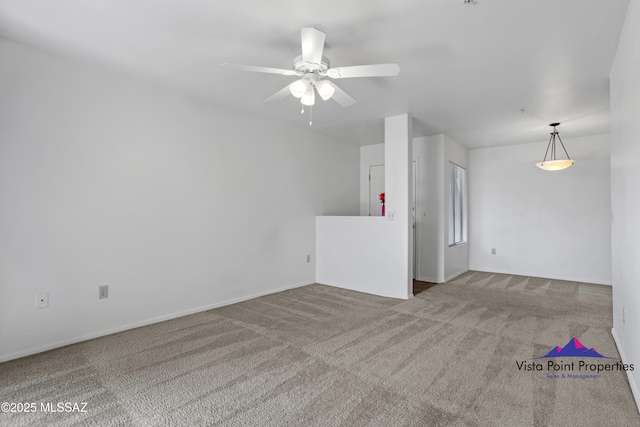 unfurnished living room with carpet and ceiling fan