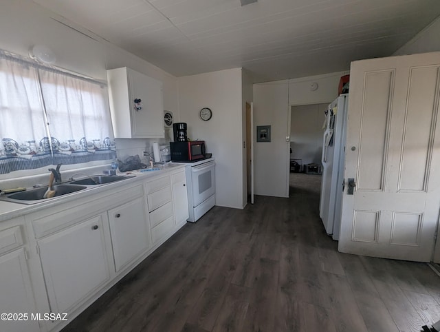 kitchen with dark wood-type flooring, light countertops, white appliances, white cabinetry, and a sink