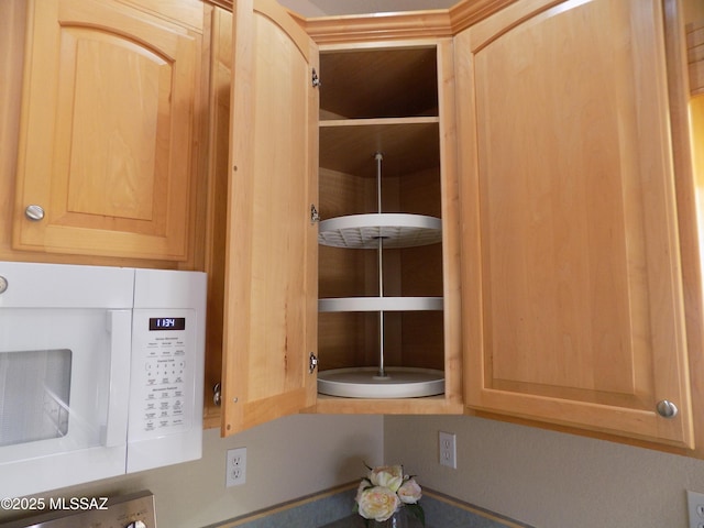 11092 N Eagle Crest Dr, Tucson, AZ 85737 - kitchen view of white microwave and light brown cabinets