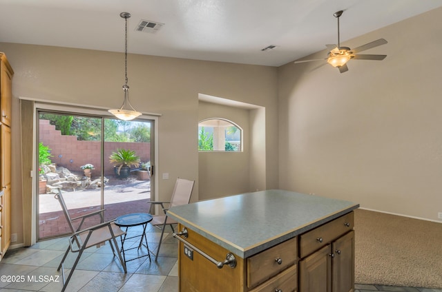 11092 N Eagle Crest Dr, Tucson, AZ 85737 - kitchen with a kitchen island, ceiling fan, pendant lighting, and vaulted ceiling