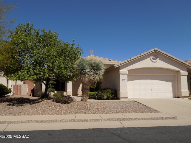 11092 N Eagle Crest Dr, Tucson, AZ 85737 - view of front facade featuring a garage, concrete driveway, and stucco siding