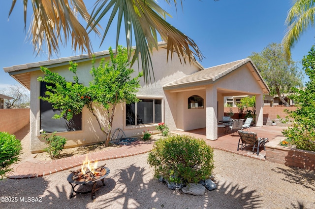 11092 N Eagle Crest Dr, Tucson, AZ 85737 - back of house featuring an outdoor fire pit, stucco siding, and a patio
