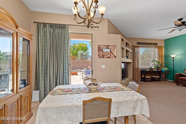 carpeted dining room featuring ceiling fan with notable chandelier