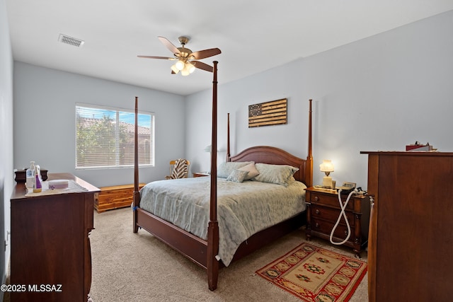 bedroom featuring visible vents, light carpet, and ceiling fan