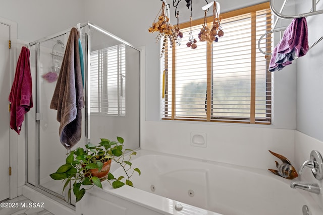 full bathroom with a tub with jets and a stall shower