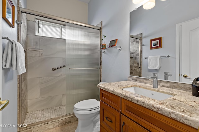 full bath featuring a shower stall, toilet, and vanity