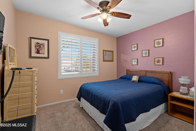 bedroom featuring ceiling fan, baseboards, and carpet