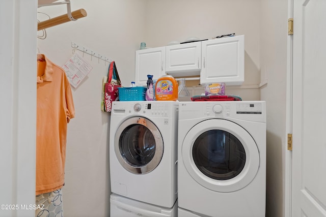 laundry room with washing machine and dryer and cabinet space