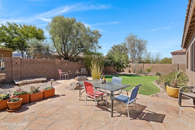 view of patio with outdoor dining area and a fenced backyard