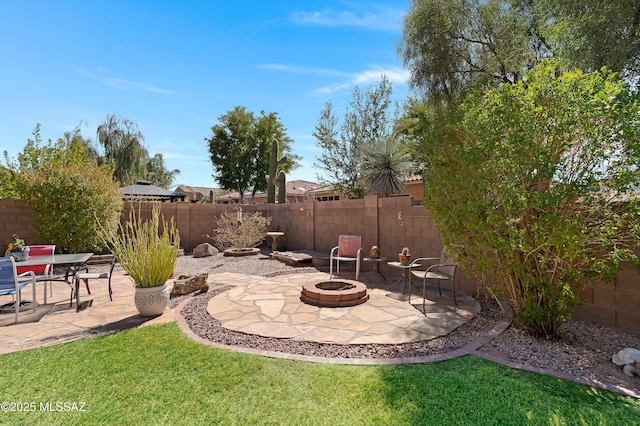 view of yard with a patio, a fire pit, and a fenced backyard