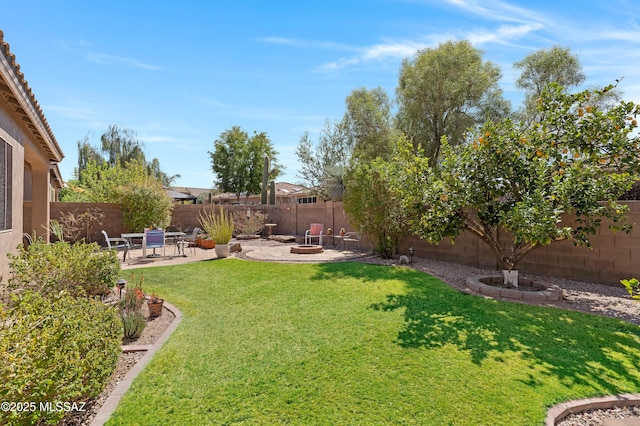 view of yard with a patio, a fire pit, and a fenced backyard