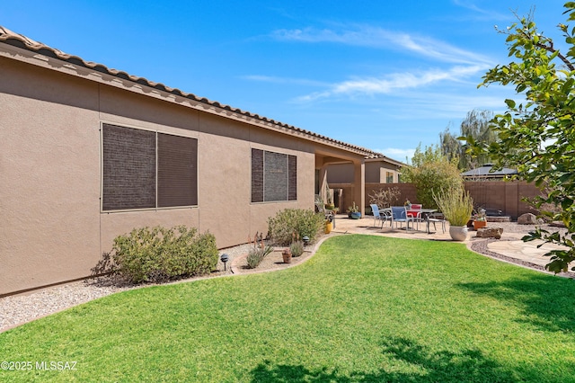 view of yard featuring fence and a patio area