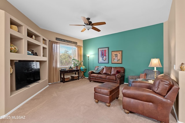 living room featuring built in features, baseboards, ceiling fan, and carpet floors