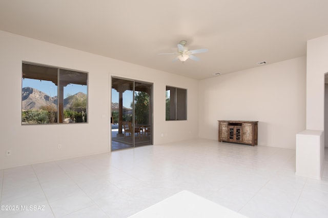 unfurnished room with a ceiling fan and visible vents