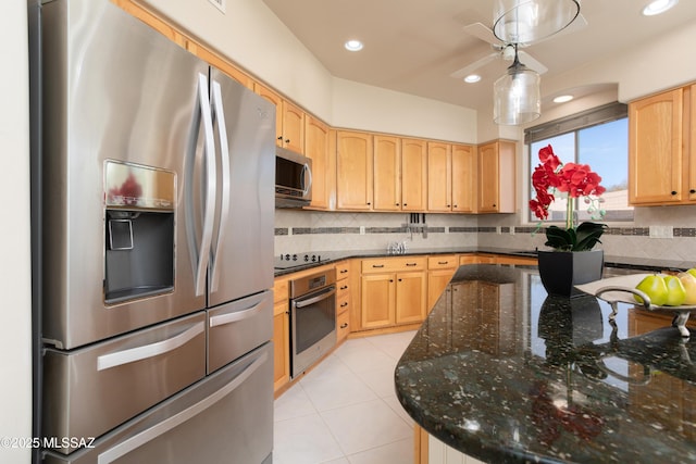 kitchen with tasteful backsplash, light brown cabinets, light tile patterned floors, dark stone countertops, and appliances with stainless steel finishes