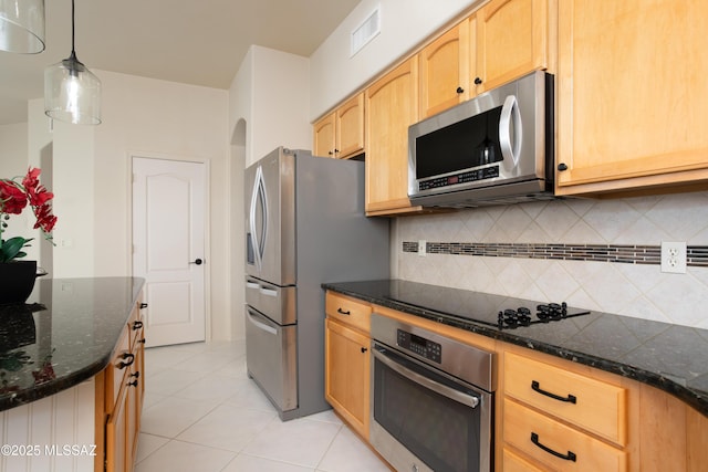 kitchen featuring visible vents, light brown cabinetry, hanging light fixtures, appliances with stainless steel finishes, and backsplash