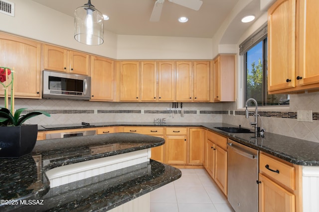 kitchen featuring visible vents, light tile patterned flooring, a sink, light brown cabinetry, and stainless steel appliances