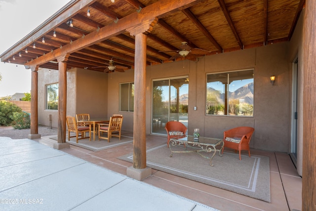 view of patio with outdoor dining area and a ceiling fan