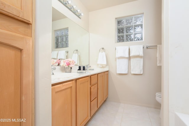 full bath with tile patterned floors, toilet, double vanity, and a sink