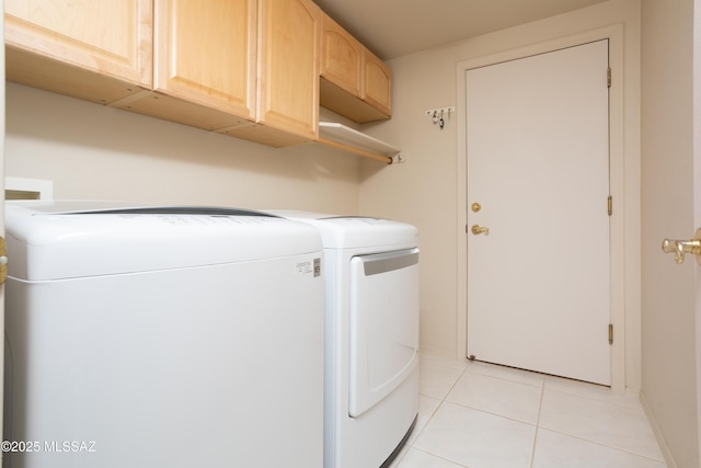 laundry area with washer and dryer, cabinet space, and light tile patterned flooring