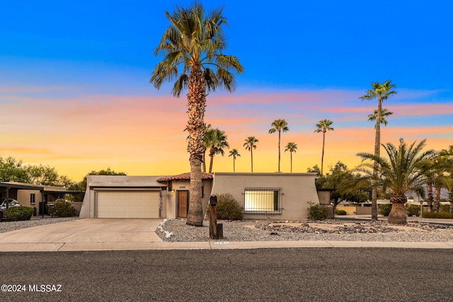 view of front of property with stucco siding, driveway, and an attached garage