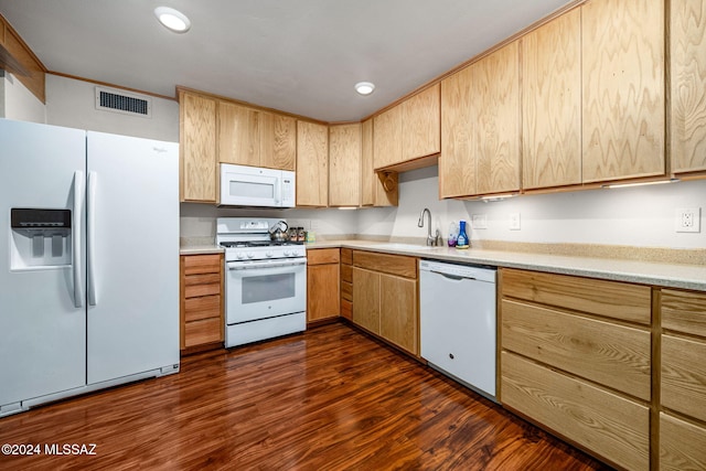 kitchen with visible vents, a sink, dark wood-style floors, white appliances, and light countertops