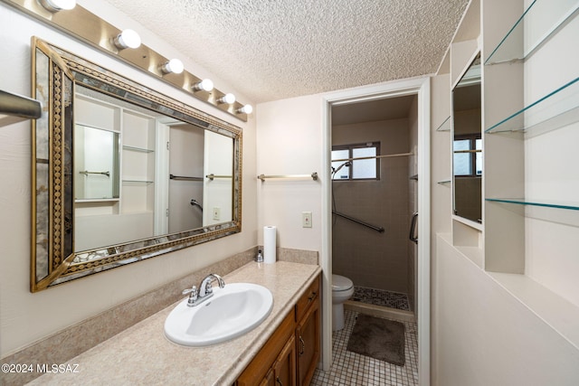 full bath with a shower stall, toilet, vanity, tile patterned floors, and a textured ceiling