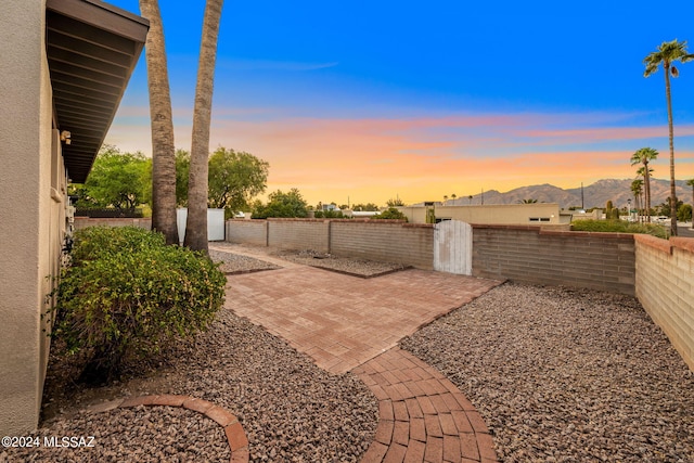 view of yard featuring a patio, a gate, fence private yard, and a mountain view