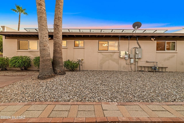 back of property featuring stucco siding