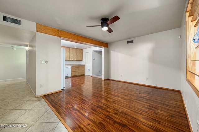 unfurnished living room with ceiling fan, visible vents, baseboards, and light wood-style flooring