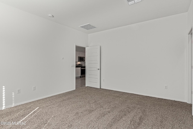 unfurnished room featuring carpet flooring, baseboards, and visible vents