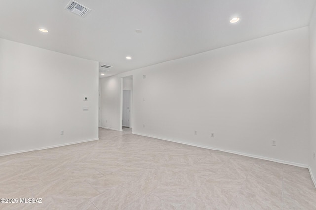 spare room featuring recessed lighting, visible vents, and baseboards