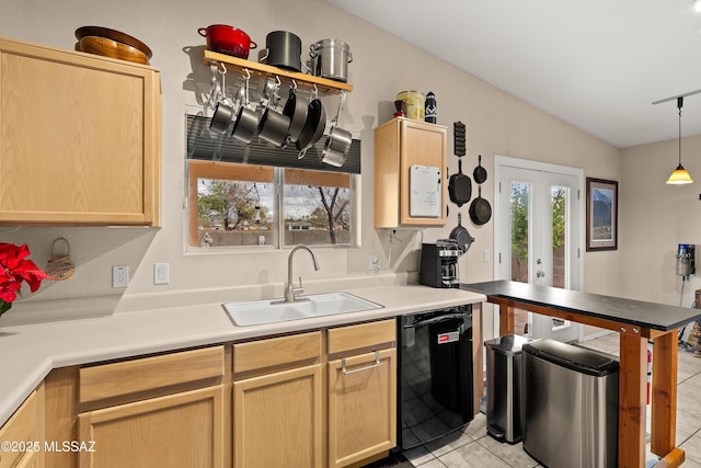 kitchen featuring black dishwasher, vaulted ceiling, light tile patterned floors, french doors, and a sink